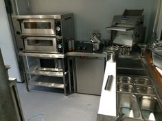 an industrial kitchen with stainless steel appliances