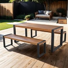 a wooden table sitting on top of a wooden deck next to a chair and bench