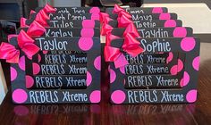 pink and black polka doted signs with bows on them