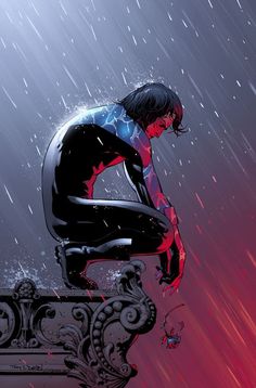 a man sitting on top of a bench in the rain with his hands over his knees