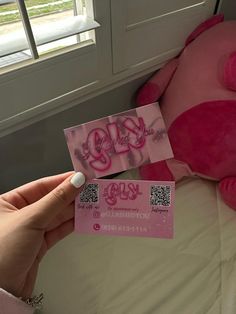 someone is holding up a pink teddy bear and ticket to the show it's name