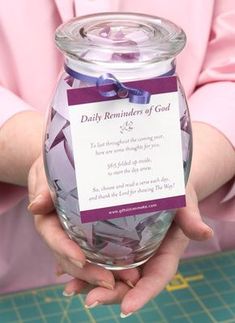 a person holding a jar filled with purple confetti