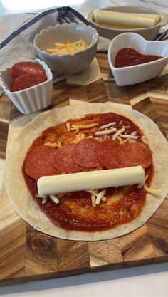 the pizza is prepared and ready to be put into the oven