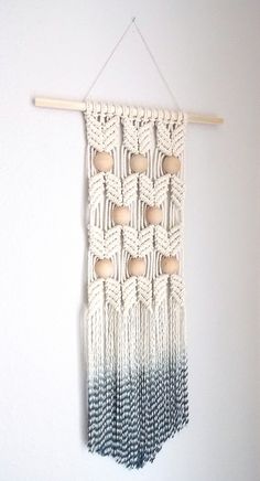 a wall hanging with macrame and wooden beads