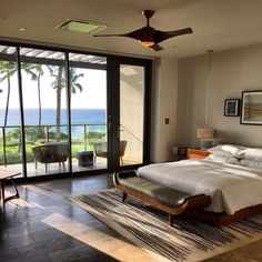 a bedroom with a large bed and sliding glass doors leading to the outside patio area