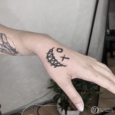 a person's hand with a tattoo on it