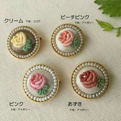 four different types of buttons with flowers on them