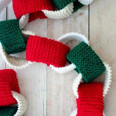 crocheted christmas stocking on white wood floor with red and green trimming