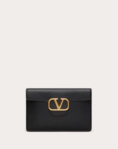 Valentino Garavani Locò large clutch bag in calfskin leather with metallic VLogo Signature detail. - Antique brass finish logo and hardware - Nappa leather lining. Interior: open slip pocket and three card slots - Dimensions: W28xH19xD1 cm / W11xH7.4xD0.3 in. - Made in Italy Evening Clutch Bag With Logo Plaque, Evening Clutch Bags With Logo Plaque, Evening Clutch With Logo Plaque, Elegant Formal Wallets With Logo, Luxury Clutch Bag With Logo Plaque, Luxury Evening Wallets With Branded Hardware, Clutch Outfit, Valentino Wallet, Valentino Clutch