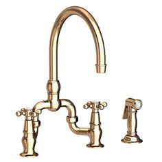 a golden faucet with two handles and nozzles