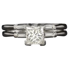 a princess cut diamond ring with baguettes