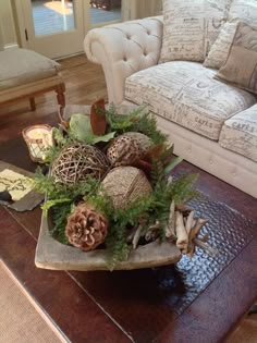 a living room filled with furniture and lots of decorations on top of a table in front of a couch