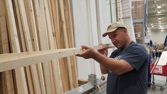 a man is working on some wood in a shop