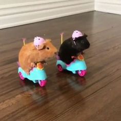 two small toy mice riding on top of each other