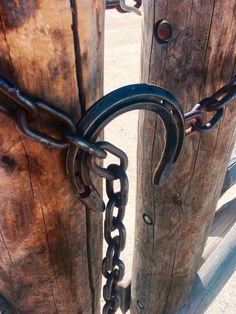 two wooden posts with chains attached to them