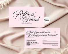 two pink and white business cards with the words refer friend written on them in cursive writing