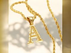 📿 Showcase your style with this A-Z Letters Gold Plated Initial Pendant Necklace! Featuring a sleek rope chain and crafted from high-quality materials, this alphabet letter necklace is perfect for both women and men. The English letter design adds a personalized touch, making it a great accessory for everyday wear or a chic gift. 🔠 Letter Jewelry, L Alphabet, English Letter, Letter Design, Initial Pendant Necklace, Chic Gifts, Initial Pendant, Letter Necklace, Rope Chain