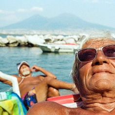 an older man and young woman relaxing on a boat