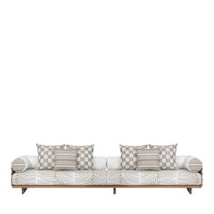 two white couches with checkered cushions and pillows on them against a white wall