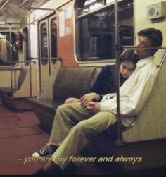 two people sitting on a subway train looking at their cell phones, with the caption you are my forever and always