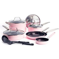 pink pots and pans with utensils on a white background