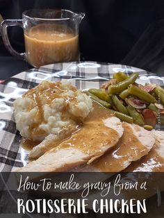 a plate with chicken, mashed potatoes and gravy on it next to a pitcher of gravy