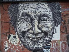 a drawing of a man's face on the side of a building