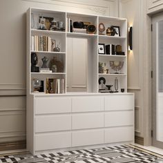 a white bookcase filled with lots of books on top of a floor next to a window