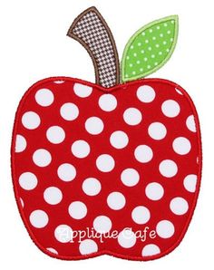 an apple applique on a white shirt with polka dots and a green leaf