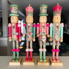 three wooden nutcrackers are standing next to each other on top of a counter