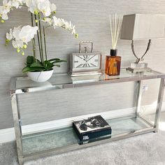 a glass table with flowers and books on it