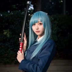 a woman with long blue hair holding a baseball bat in her hand and posing for the camera