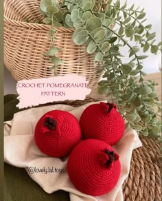 three crocheted pomegranates sitting on top of a table