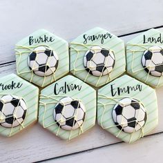 four cookies decorated with soccer balls and names