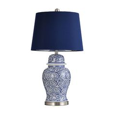 a blue and white vase lamp with a blue shade on it's base is shown