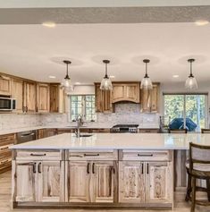 a large kitchen with wooden cabinets and an island