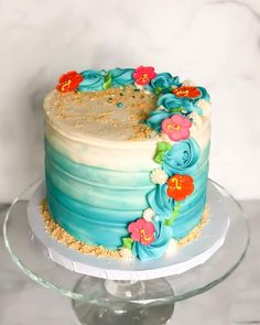 a blue and white cake sitting on top of a glass plate