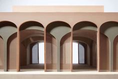 an architectural model of a building with arches and doorways