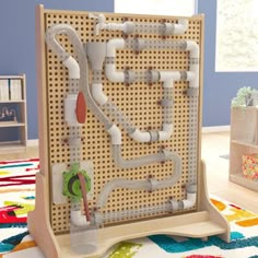 a wooden structure with pipes on it in the middle of a room filled with children's toys