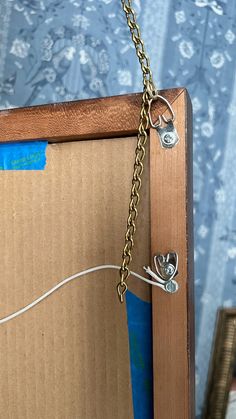 an open cardboard box with a chain hanging from it