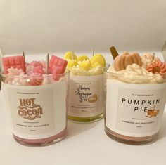 three cups filled with different types of desserts on top of a white countertop