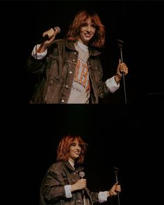 a woman holding a microphone while standing next to a man with long hair and wearing a denim jacket