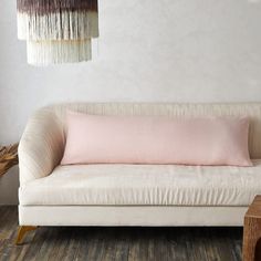 a white couch sitting next to a wooden table