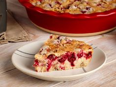 a piece of cake on a plate next to a red dish