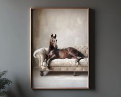 a brown horse laying on top of a white couch next to a potted plant