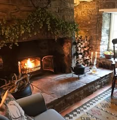 a living room filled with furniture and a fire place in the middle of a stone fireplace