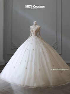 a white wedding dress on display in front of a wall with the words hey couture