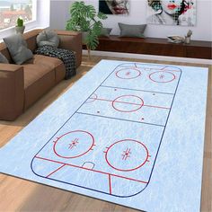 a living room with couches and a rug that has a hockey rink on it