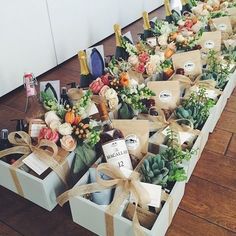 several boxes filled with wine bottles and flowers