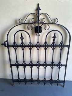 a wrought iron headboard with an arrow on it